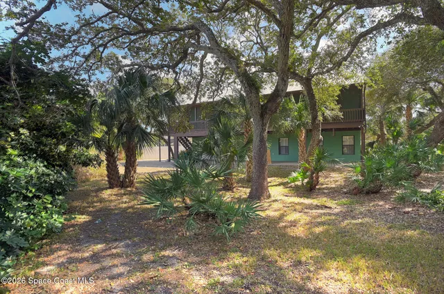 a view of a house with a tree