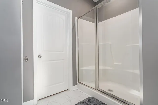 a bathroom with a glass shower door