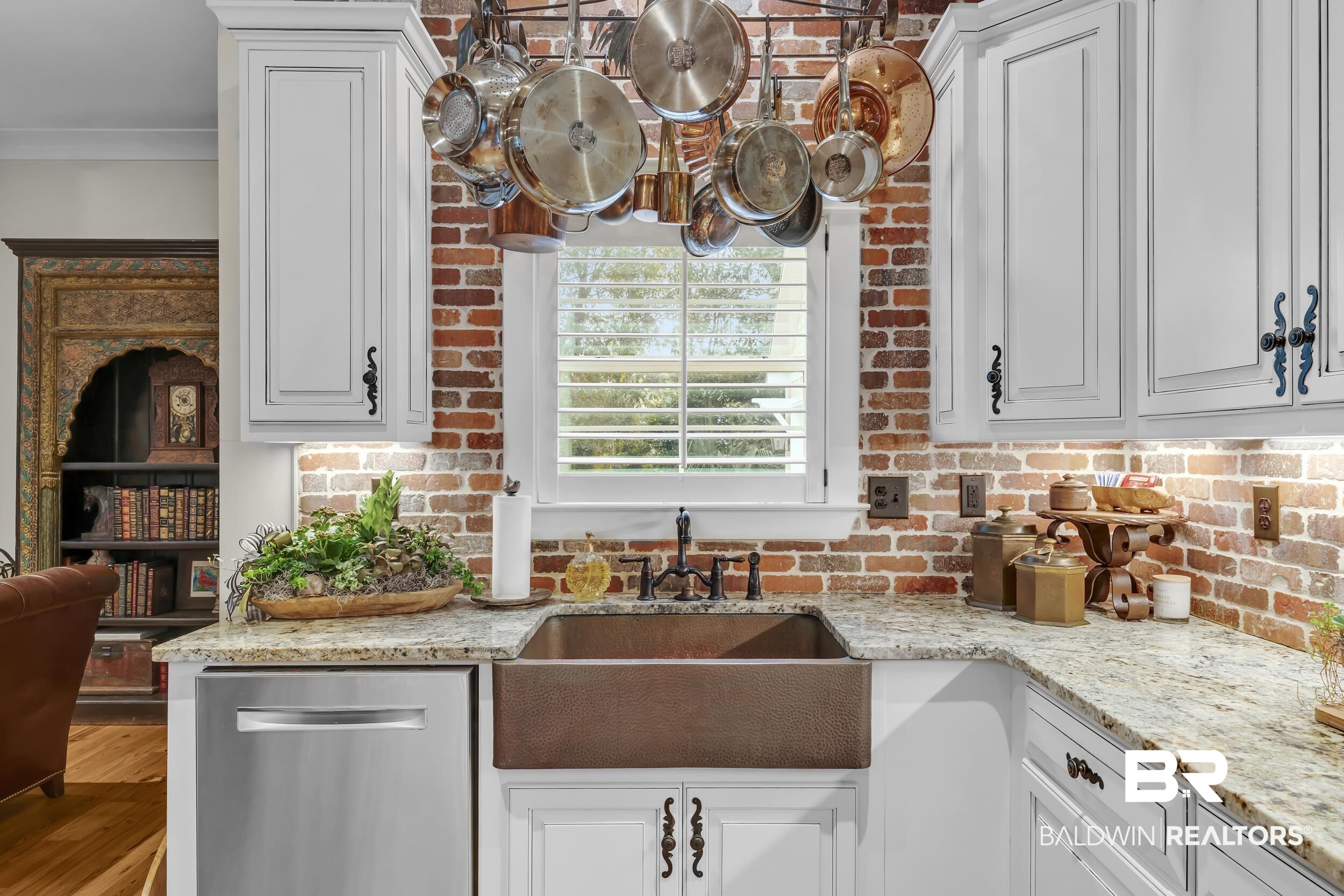 12161 Jessamine Street Magnolia Springs, AL 36555 - Photo 18 of 70 Kitchen with light stone countertops, dishwasher, and white cabinetry