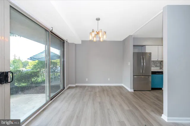 a view of a refrigerator in kitchen and wooden floor