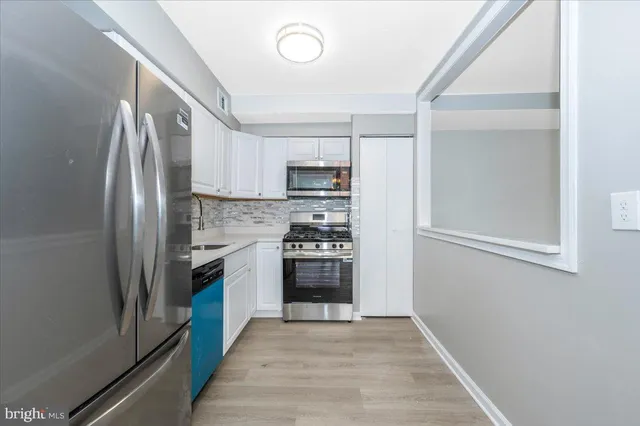 a kitchen with granite countertop a refrigerator and a stove