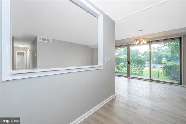 a view of an entryway with wooden floor