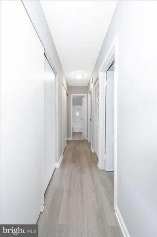a view of a hallway with wooden floor