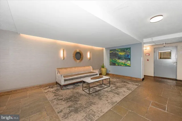 a view of a room with furniture and a window