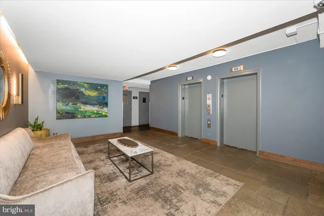 a living room with furniture and a rug