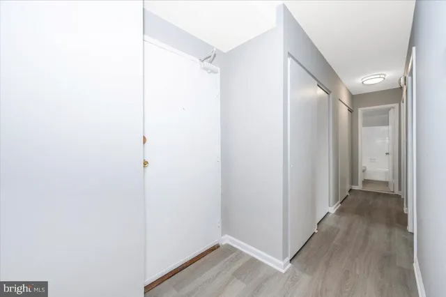 a view of a hallway with wooden floor