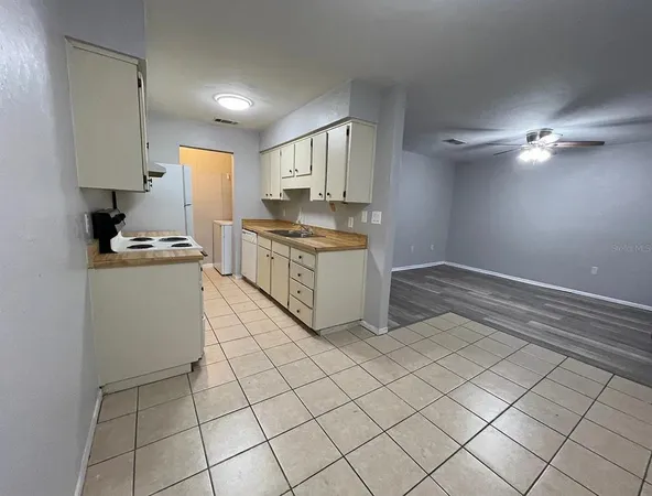 a kitchen with a stove cabinets and a refrigerator