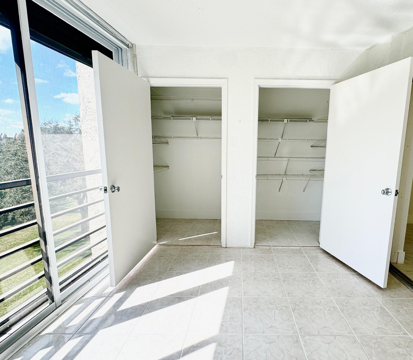 9170 Southwest 14th Street, Unit 4405 Boca Raton, FL 33428 - Photo 8 of 48 an empty room with windows