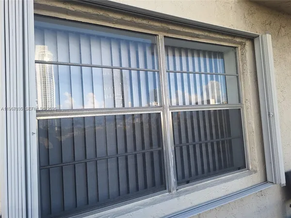 a living room with a couch and a potted plant