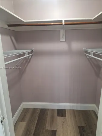 a bathroom with a granite countertop toilet sink and mirror
