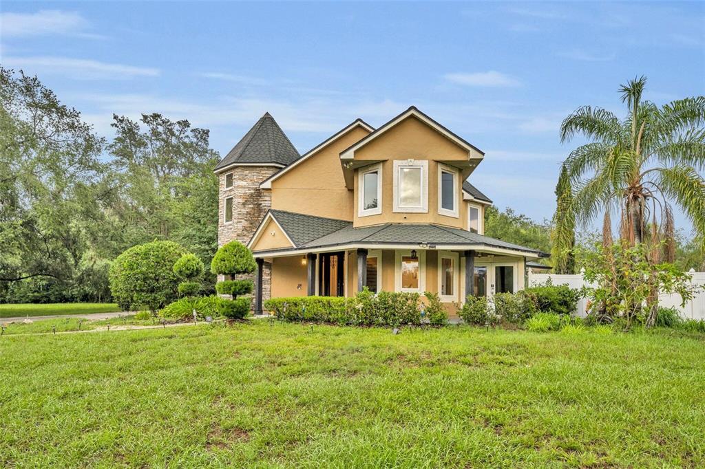 1415 Brumley Road Chuluota, FL 32766 - Photo 12 of 46 a front view of a house with a yard
