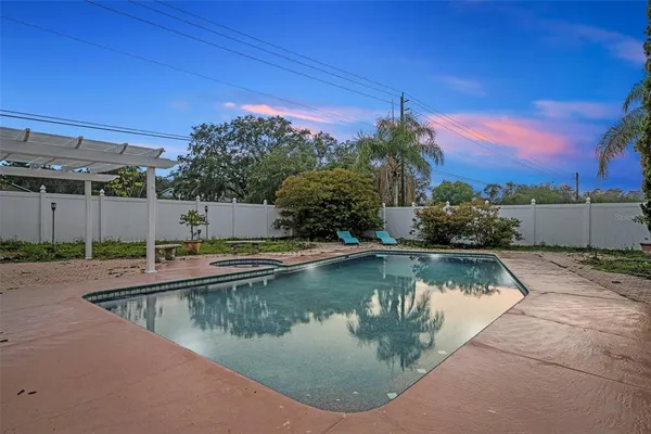 a swimming pool with outdoor seating and yard