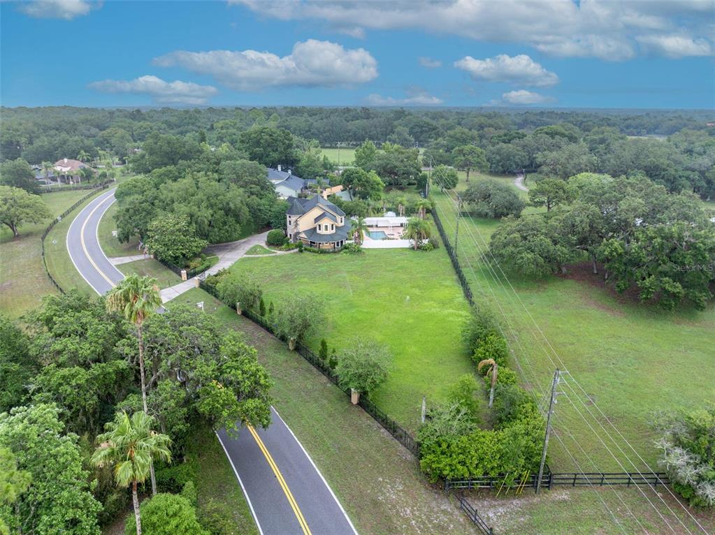 1415 Brumley Road Chuluota, FL 32766 - Photo 20 of 46 aerial view of a house with a yard and lake view