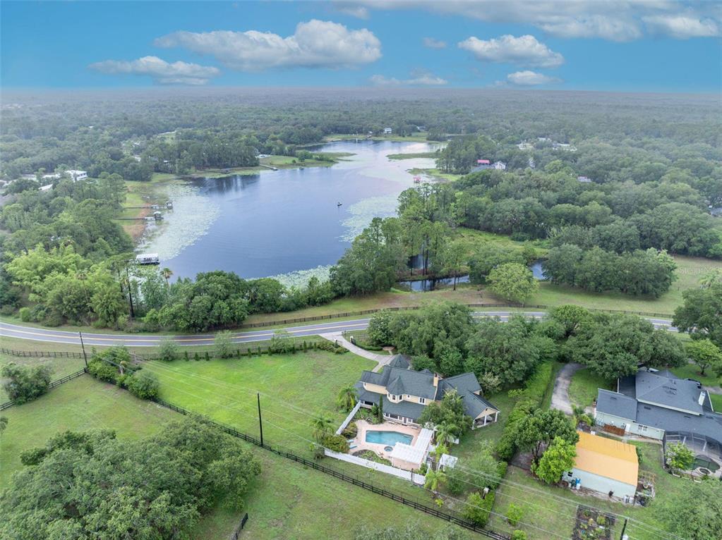 1415 Brumley Road Chuluota, FL 32766 - Photo 26 of 46 an aerial view of a house with a yard and lake view
