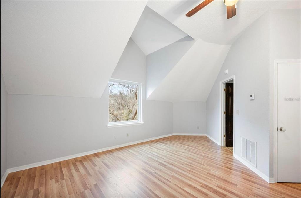 1415 Brumley Road Chuluota, FL 32766 - Photo 38 of 46 an empty room with wooden floor and windows