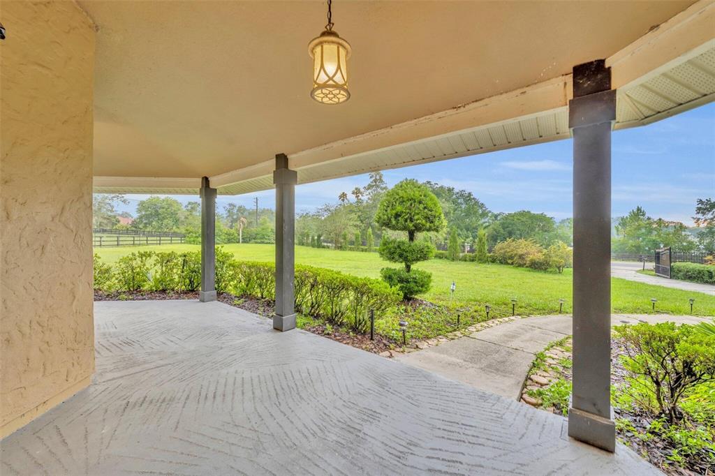 1415 Brumley Road Chuluota, FL 32766 - Photo 5 of 46 a view of a porch with a floor to ceiling window