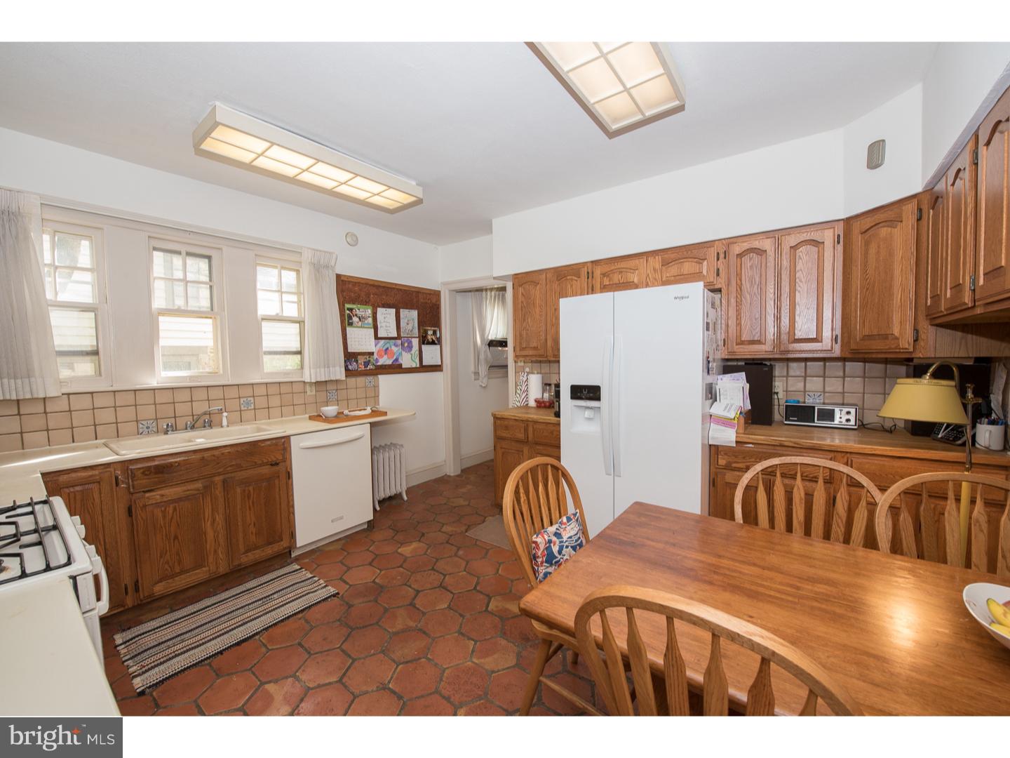 540 Manor Road Wynnewood, PA 19096 - Photo 11 of 25 a kitchen with granite countertop a stove a sink and a refrigerator
