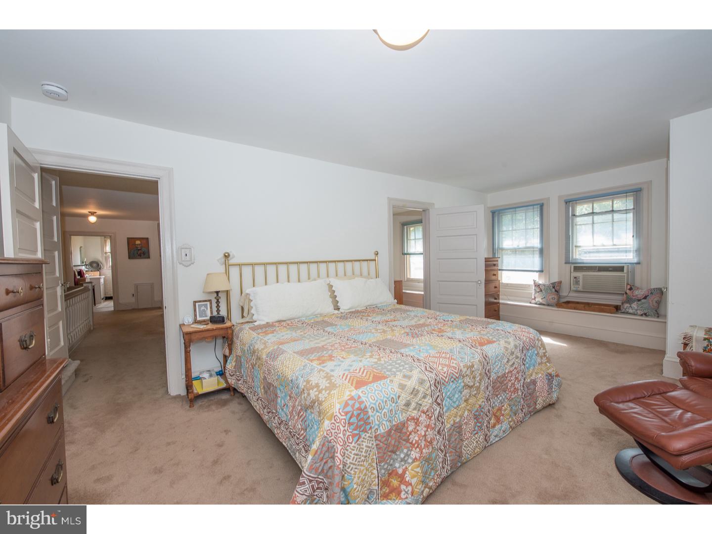 540 Manor Road Wynnewood, PA 19096 - Photo 16 of 25 a bedroom with a bed a mirror and lamp