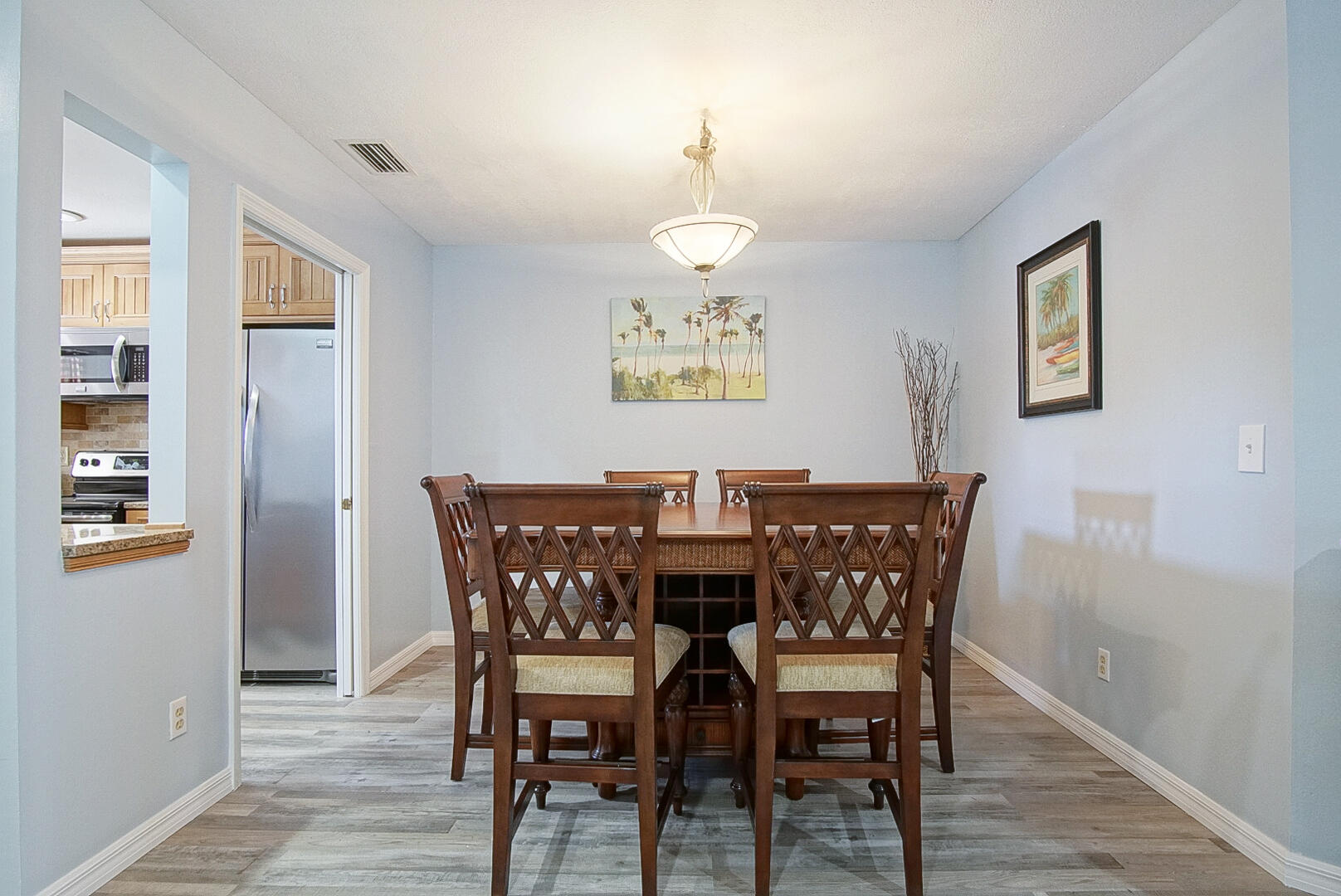 6041 Southeast Landing Way Stuart, FL 34997 - Photo 15 of 30 a view of a dining room with furniture and wooden floor