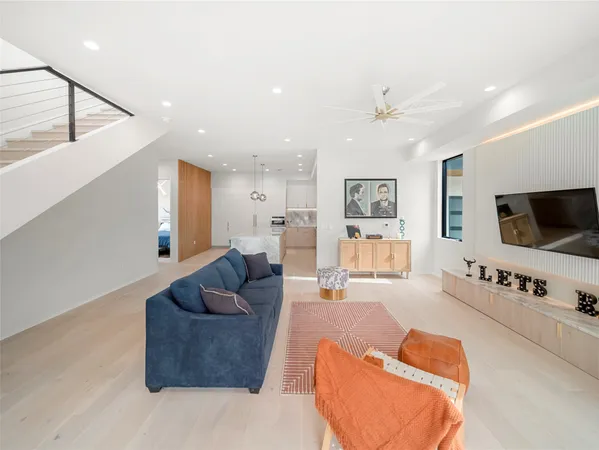 a living room with furniture and kitchen view