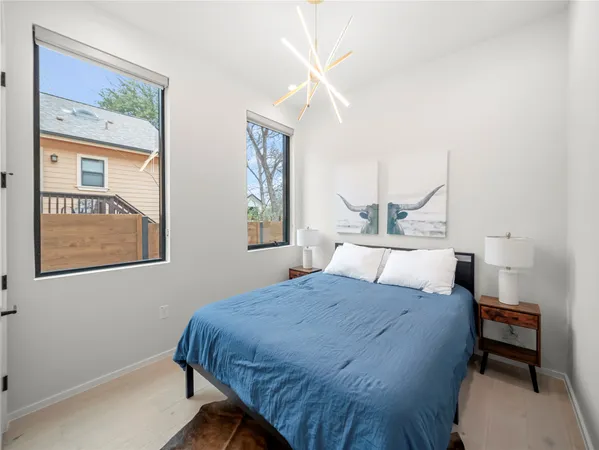 a large bed sitting in a bedroom next to a window