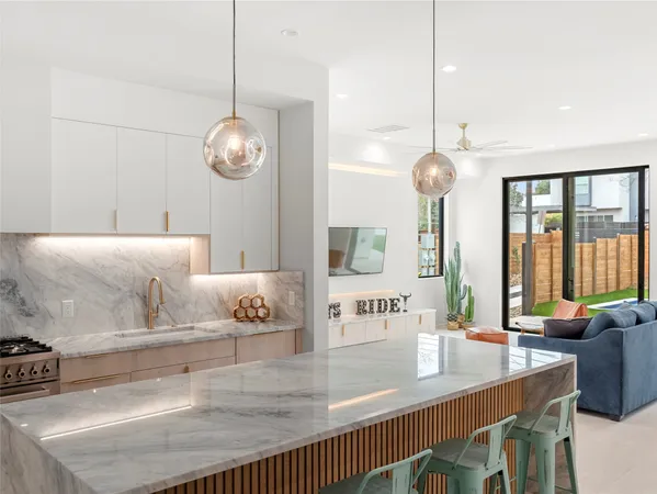 a kitchen with stainless steel appliances granite countertop a stove a sink and a refrigerator
