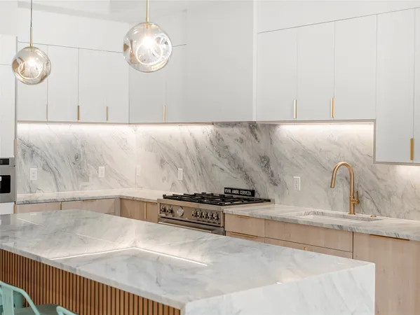 a kitchen with granite countertop cabinets and wooden floor