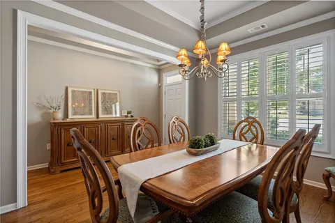 a living room with furniture kitchen and a table