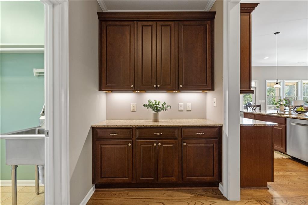 319 Laurel Lookout Hills Canton, GA 30114 - Photo 33 of 80 a sink with granite countertop wooden cabinets