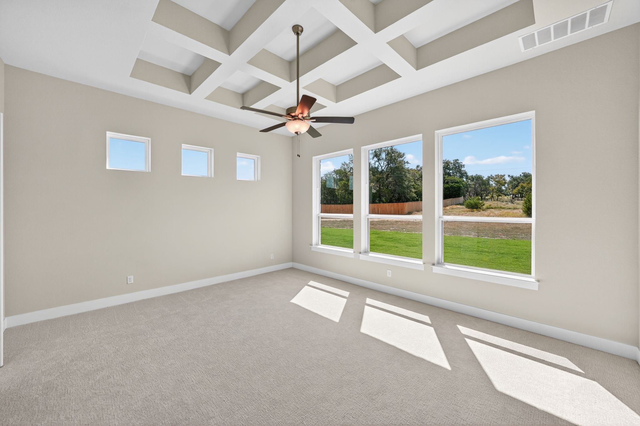 205 Three Rivers Road Georgetown, TX 78633 - Photo 11 of 32 an empty room with chandelier fan and windows