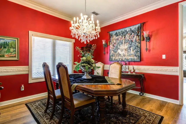 a view of a dining room with furniture and chandelier