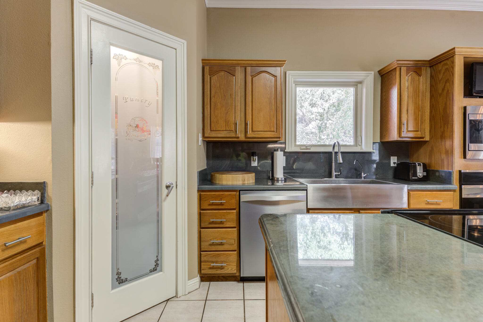 30 West Lakeshore Drive Ransom Canyon, TX 79366 - Photo 15 of 59 a kitchen with stainless steel appliances granite countertop a refrigerator a stove a sink and a window