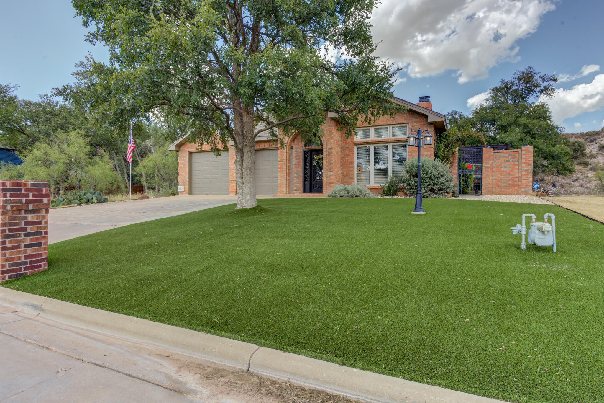 30 West Lakeshore Drive Ransom Canyon, TX 79366 - Photo 2 of 59 a front view of a house with a garden