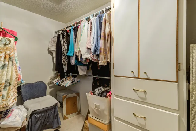 a living room with furniture a chandelier and a flat screen tv