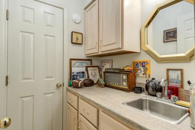 a bedroom with two beds and a chandelier