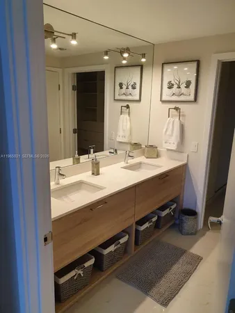 a bathroom with a sink mirror and vanity