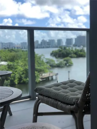 a roof deck with table and chairs and potted plants