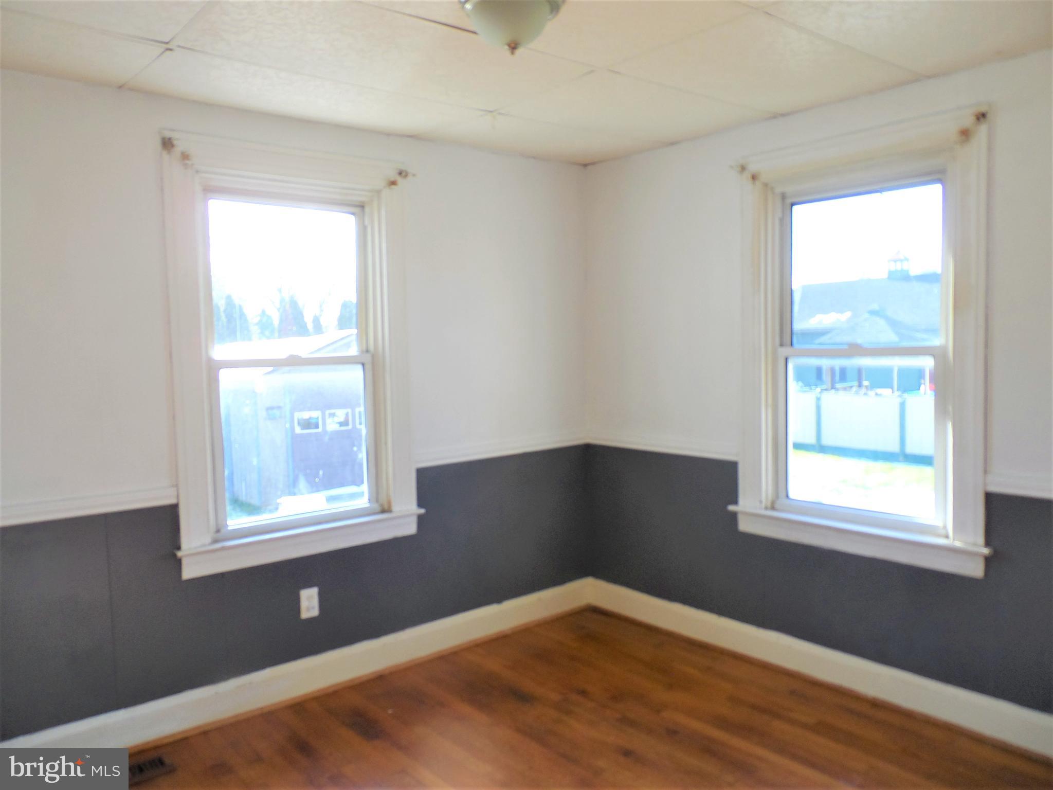 2211 Sparrows Point Road Baltimore, MD 21219 - Photo 19 of 28 an empty room with wooden floor and windows