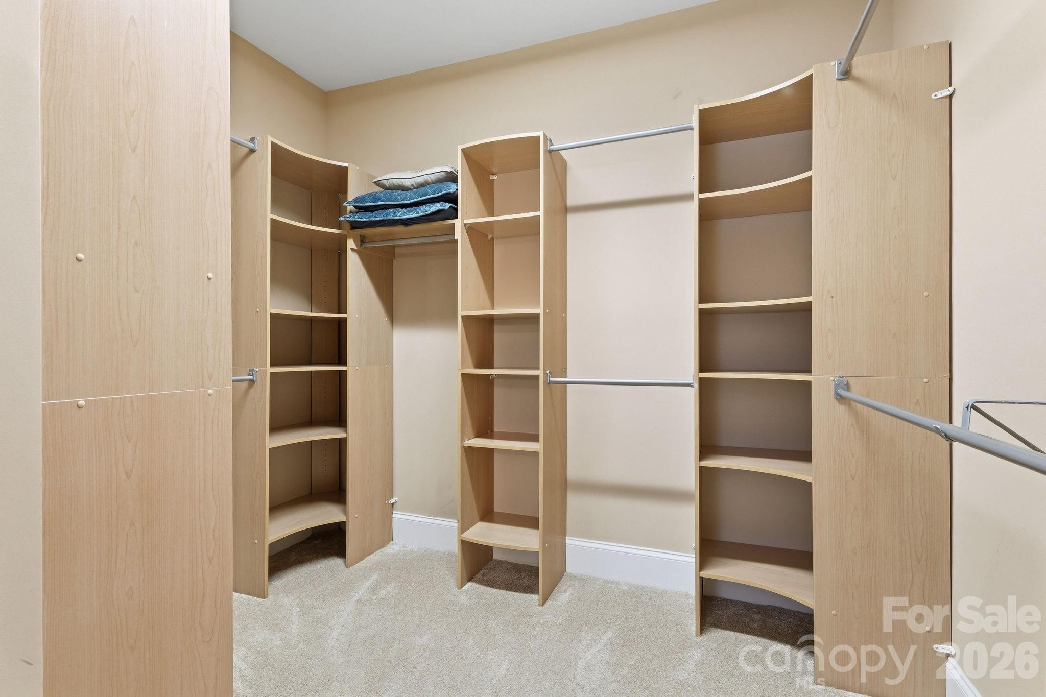 235 Grey Road Davidson, NC 28036 - Photo 19 of 42 a view of walk in closet with empty racks