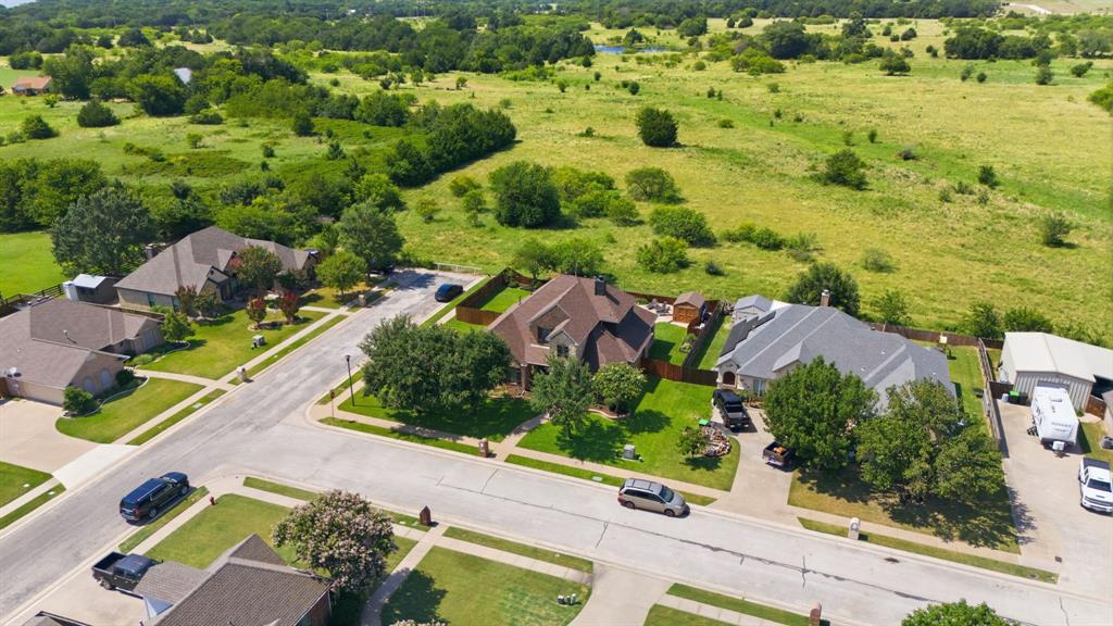 600 Aspen Street Pilot Point, TX 76258 - Photo 37 of 39 Aerial perspective showcasing a residential neighborhood with surrounding green spaces