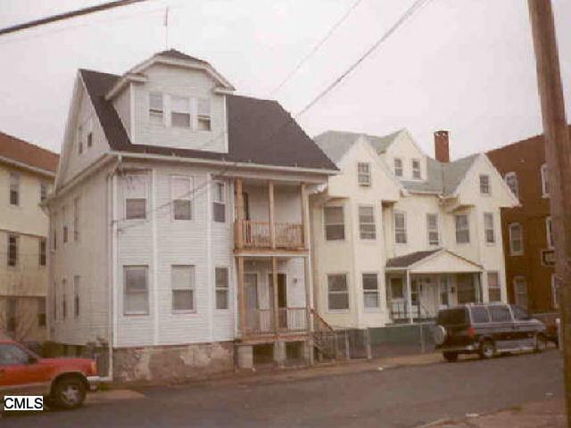 164 George Street Bridgeport, CT 06604 - Photo 1 of 1 a front view of a building with lot of cars parked