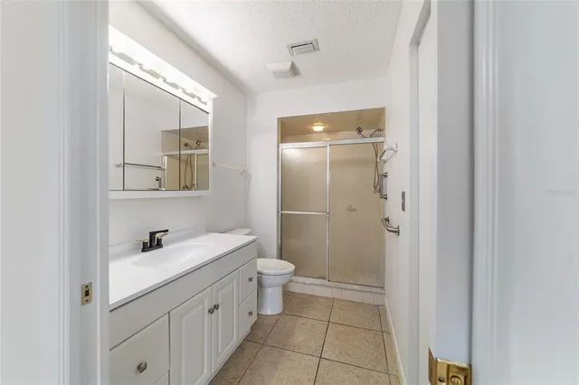 a bathroom with a double vanity sink mirror and toilet