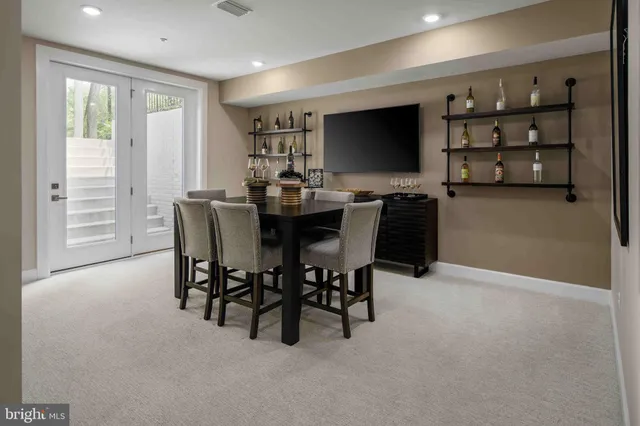 a view of a dining room with furniture and a flat screen tv