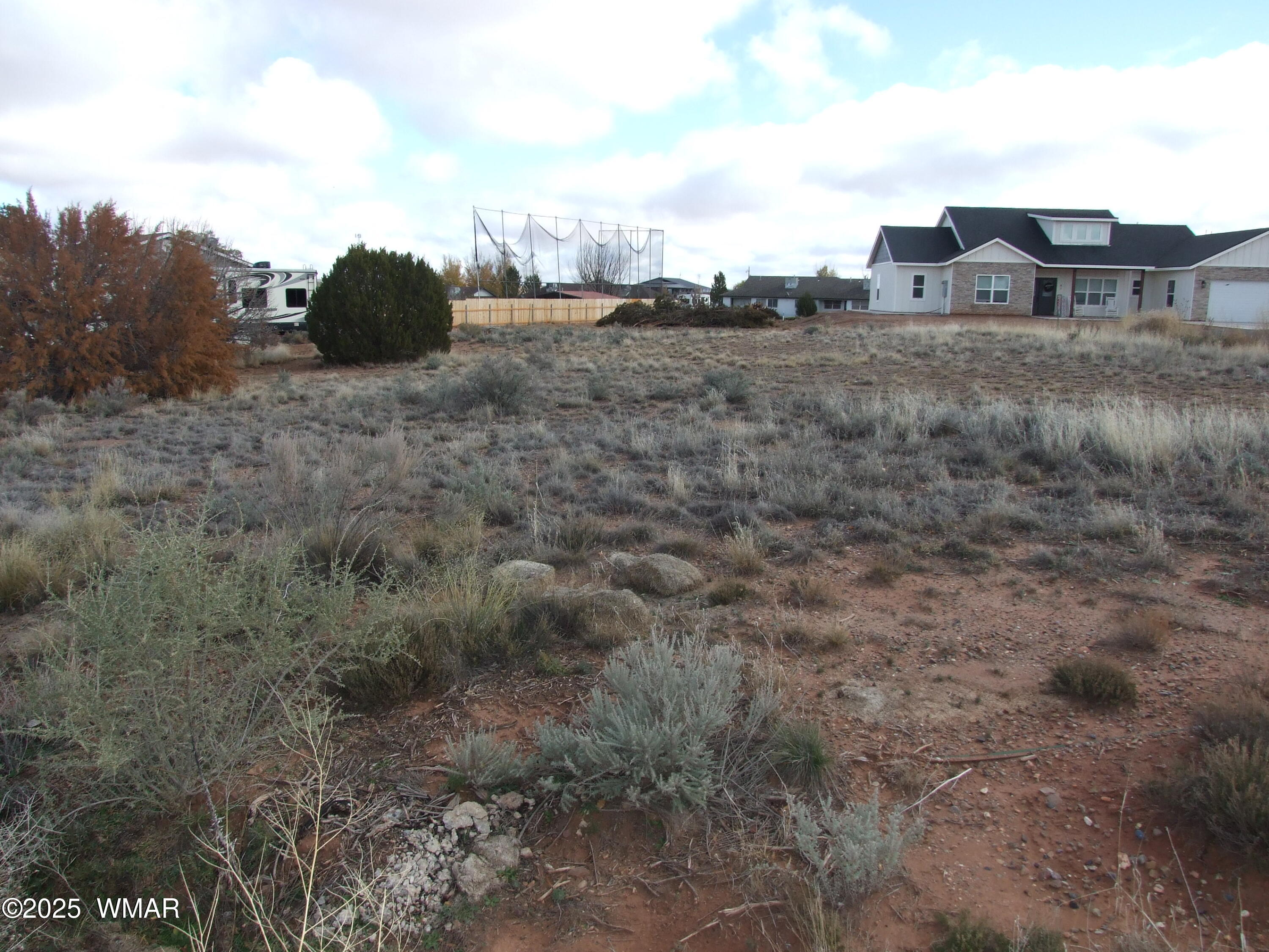 89 Lyon Gate Drive Snowflake, AZ 85937 - Photo 4 of 6 a view of a dry yard with wooden fence