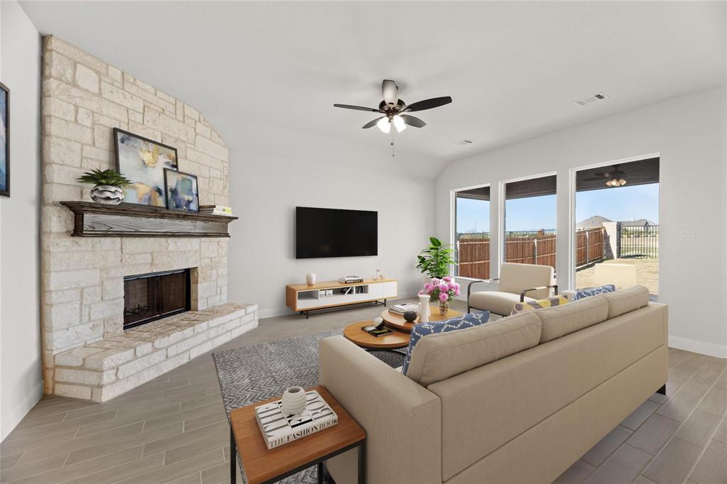 3841 Eagles Bluff Road Midlothian, TX 76065 - Photo 2 of 7 Living area with a stone fireplace, wood finish floors, and ceiling fan