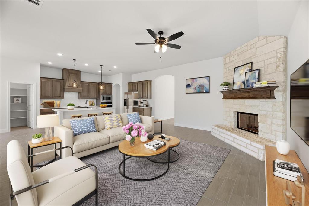 3841 Eagles Bluff Road Midlothian, TX 76065 - Photo 3 of 7 Living room featuring recessed lighting, a stone fireplace, arched walkways, light wood-style floors, and ceiling fan
