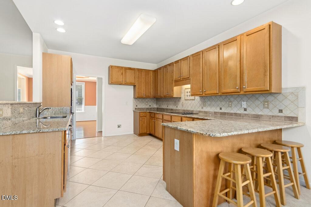 4800 Rhythm Drive Apex, NC 27539 - Photo 12 of 32 a kitchen with a sink stove and cabinets