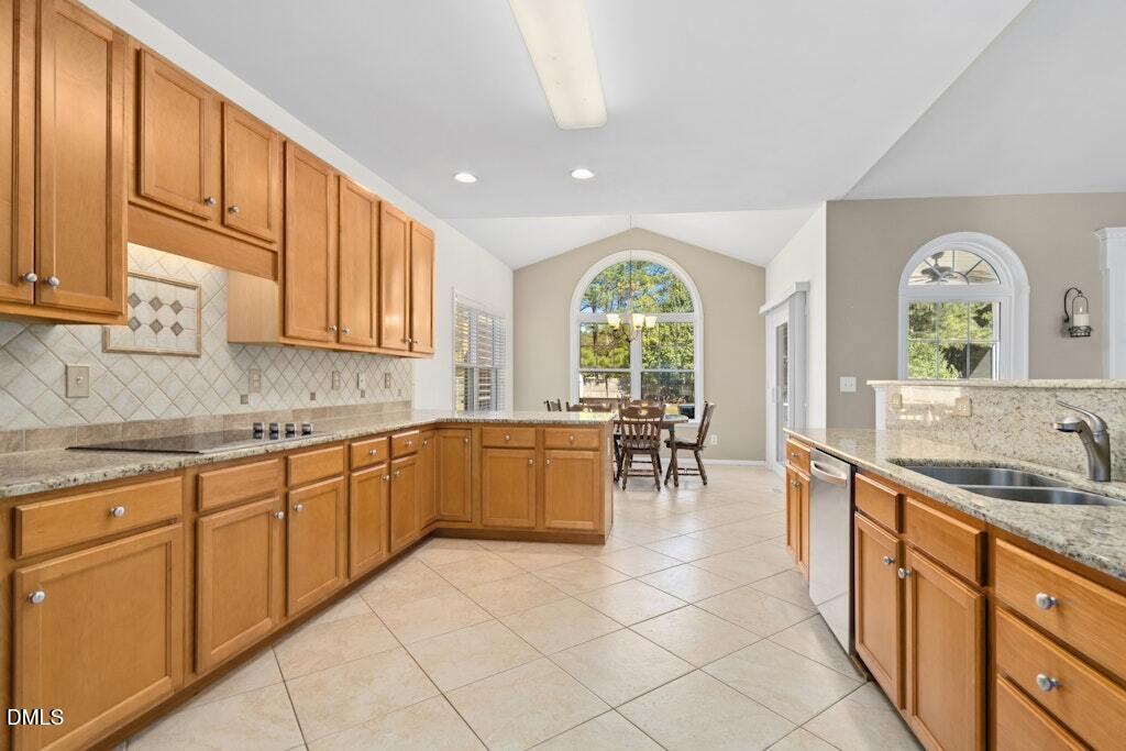 4800 Rhythm Drive Apex, NC 27539 - Photo 14 of 32 a large kitchen with stainless steel appliances granite countertop a large window a sink and cabinets