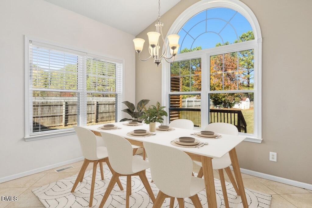 4800 Rhythm Drive Apex, NC 27539 - Photo 15 of 32 a view of a dining room with furniture large windows and wooden floor
