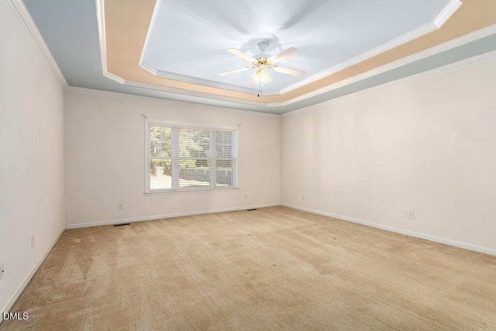 4800 Rhythm Drive Apex, NC 27539 - Photo 17 of 32 en empty room with windows and chandelier fan